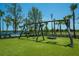 Wooden swing set and tire swing in a park at 13463 Nobilio St, Venice, FL 34293