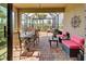 Relaxing screened patio with seating and dining areas at 13463 Nobilio St, Venice, FL 34293