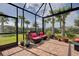 Enjoy this screened patio with seating and a view of the backyard at 13463 Nobilio St, Venice, FL 34293