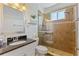 Bathroom with granite counters, framed mirror and a glass enclosed tiled shower at 1537 Monarch Dr, Venice, FL 34293