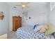 Bright bedroom with light blue walls, ceiling fan, closet, and a comfortable queen-size bed at 1537 Monarch Dr, Venice, FL 34293