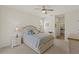 Light bedroom boasts a ceiling fan, cozy bedding, and ample natural light at 1537 Monarch Dr, Venice, FL 34293