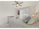 Bedroom with bright natural light from window offers comfy bedding and dresser at 1537 Monarch Dr, Venice, FL 34293