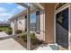 Covered front porch showcasing a black front door with decorative wreath and a welcome mat at 1537 Monarch Dr, Venice, FL 34293