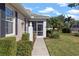 Inviting front porch featuring a screened entryway and decorative pineapple column at 1537 Monarch Dr, Venice, FL 34293