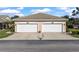 Two-car garage with white doors and concrete driveway, offering convenient parking at 1537 Monarch Dr, Venice, FL 34293