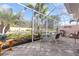 Spacious screened patio offers tranquil views of landscaped lawn and clear blue skies at 1537 Monarch Dr, Venice, FL 34293