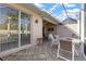 Covered patio includes an outdoor dining table, lounge chairs, and sliding glass doors at 1537 Monarch Dr, Venice, FL 34293