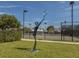 Tennis court with a statue of tennis player in front at 1537 Monarch Dr, Venice, FL 34293