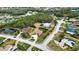 Aerial view shows a neighborhood lined with trees, ponds, and homes at 15804 29Th E St, Parrish, FL 34219