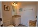 Cozy bathroom with a cream vanity, neutral walls, and tropical artwork for a relaxing atmosphere at 15804 29Th E St, Parrish, FL 34219