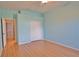 Bright bedroom with wood floors, closet, and door leading to another room at 15804 29Th E St, Parrish, FL 34219