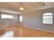 Spacious bedroom featuring a ceiling fan, tray ceiling, and hardwood floors at 15804 29Th E St, Parrish, FL 34219