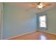 Bedroom with light blue walls, hardwood floors, and a window at 15804 29Th E St, Parrish, FL 34219