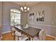 Dining room featuring a large window, modern chandelier and seating for six at 15804 29Th E St, Parrish, FL 34219