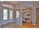 Inviting foyer with decorative glass front doors, chandelier, and access to the dining room at 15804 29Th E St, Parrish, FL 34219