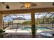 Screened-in lanai featuring a seating area, overlooking a sparkling pool and spa at 15804 29Th E St, Parrish, FL 34219