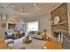 Comfortable living room featuring stone fireplace, ceiling fan and neutral color palette at 15804 29Th E St, Parrish, FL 34219