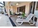 Covered patio with lounge chairs overlooking an outdoor living space and ceiling fan at 15804 29Th E St, Parrish, FL 34219