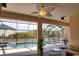 View of a screened-in pool with lounge seating and a ceiling fan at 15804 29Th E St, Parrish, FL 34219