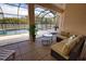 View of a screened-in pool area with outdoor seating at 15804 29Th E St, Parrish, FL 34219