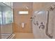 Shower with a glass enclosure, grab bars, shower seat, and overhead shower at 15804 29Th E St, Parrish, FL 34219