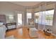 Inviting bedroom sitting area with chair, ottoman, and view of the screened-in pool at 15804 29Th E St, Parrish, FL 34219