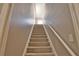 Carpeted staircase with white railing and neutral walls leading to upper level at 15804 29Th E St, Parrish, FL 34219