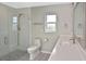 Bathroom featuring a glass shower with a rain shower head, modern sink, and a toilet at 1600 Lilliput Ct, Venice, FL 34293