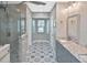 Beautiful bathroom with double vanities, tiled floors, a walk-in shower, and a window at 1600 Lilliput Ct, Venice, FL 34293