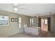 Bright bedroom featuring carpet flooring, two windows and neutral walls at 1600 Lilliput Ct, Venice, FL 34293