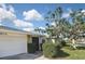 A view of the front exterior showing the garage and stone accent wall at 1600 Lilliput Ct, Venice, FL 34293