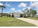 Charming single-story home with a well-manicured lawn, driveway, and a two-car garage at 1600 Lilliput Ct, Venice, FL 34293