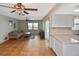 Bright living room with tile flooring, ceiling fans, and sliding doors to the outdoor pool area at 1600 Lilliput Ct, Venice, FL 34293