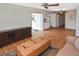 Living room featuring tile floors, built-in cabinets, and access to both an enclosed patio and an adjacent kitchen at 1600 Lilliput Ct, Venice, FL 34293