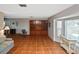 Spacious living room featuring tile flooring, large windows, and built-in shelving at 1600 Lilliput Ct, Venice, FL 34293