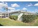 A lush, green backyard featuring a serene, screened-in pool area, offering the perfect outdoor retreat at 1600 Lilliput Ct, Venice, FL 34293