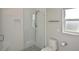 Updated shower with glass door, tiled walls, niche, and modern fixtures at 1600 Lilliput Ct, Venice, FL 34293