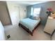 Bedroom with neutral carpet, light blue walls, a built-in closet and a window with shutters at 17 Nautical Dr, North Port, FL 34287