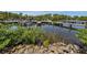 Picturesque view of multiple community boat docks lined with boats, lush greenery, and clear water on a sunny day at 17 Nautical Dr, North Port, FL 34287