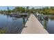 Long wooden community dock extending into the water, providing access to boat slips and scenic water views at 17 Nautical Dr, North Port, FL 34287