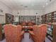 Community library boasting bookshelves filled with books, and comfortable paisley chairs at 17 Nautical Dr, North Port, FL 34287