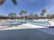 Outdoor community pool with plenty of lounge chairs, palm trees, and a comfortable setting at 17 Nautical Dr, North Port, FL 34287