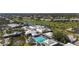 Aerial view of the community clubhouse, pools, and surrounding landscape at 174 Southampton S Pl # 345, Venice, FL 34293