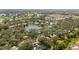 Lush community aerial featuring single-Gathering homes around a scenic lake at 174 Southampton S Pl # 345, Venice, FL 34293