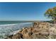 A view of the ocean with a rocky shore and waves crashing on the rocks near the beach at 174 Southampton S Pl # 345, Venice, FL 34293