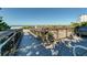 A boardwalk with a metal railing leading to a sandy beach and ocean view under a blue sky at 174 Southampton S Pl # 345, Venice, FL 34293