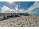 Scenic view of the fishing pier extending over the sandy beach with a cloudy sky backdrop at 174 Southampton S Pl # 345, Venice, FL 34293