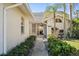 Inviting walkway leading to the front door, surrounded by manicured bushes and a well-kept lawn at 174 Southampton S Pl # 345, Venice, FL 34293