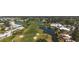 A beautiful aerial view of a golf course community featuring ponds and green spaces at 174 Southampton S Pl # 345, Venice, FL 34293